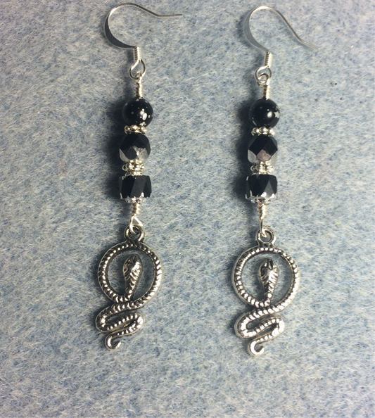 Silver coiled snake charm earrings adorned with black Czech glass beads