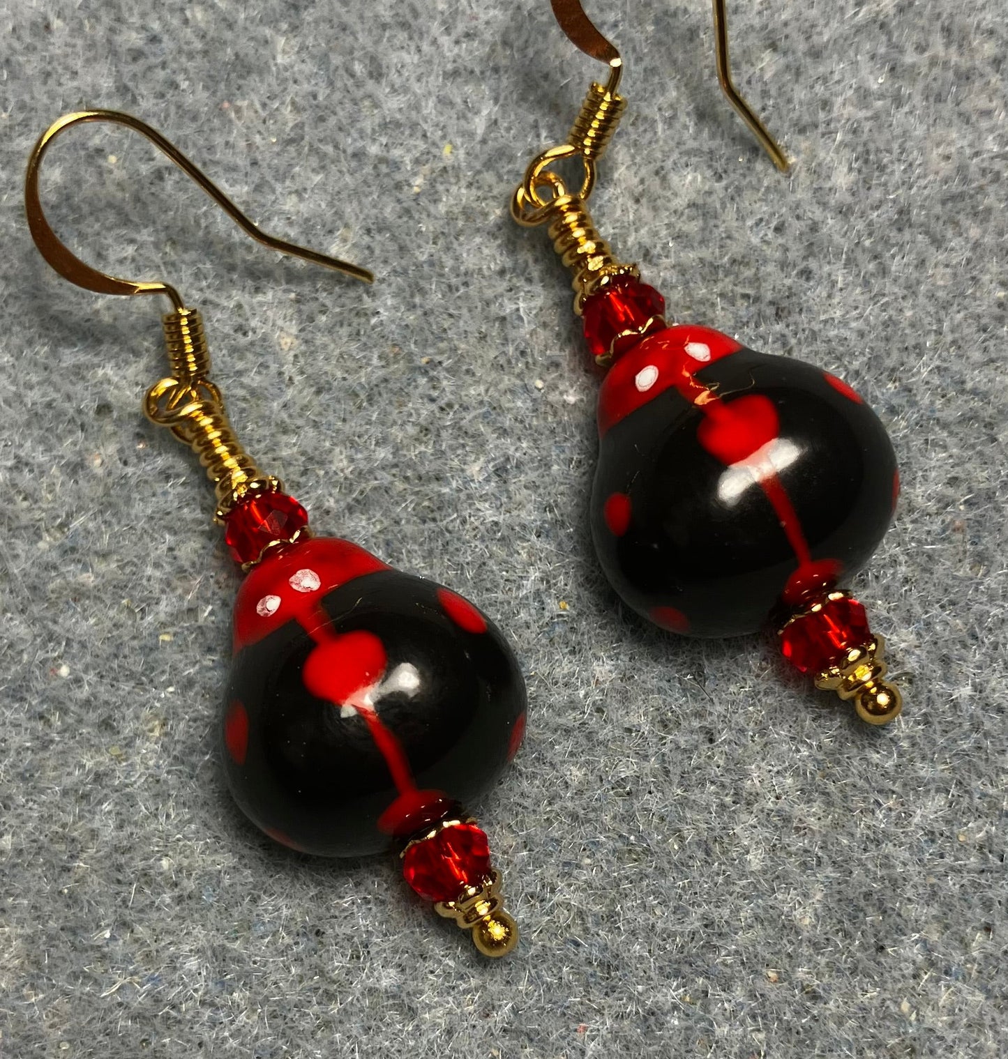 Black and red ceramic ladybug bead earrings adorned with red Chinese crystal beads.