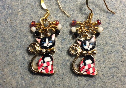 Red, white, and black enamel cat charm earrings adorned with small dangling red, white, and black Chinese crystal beads.