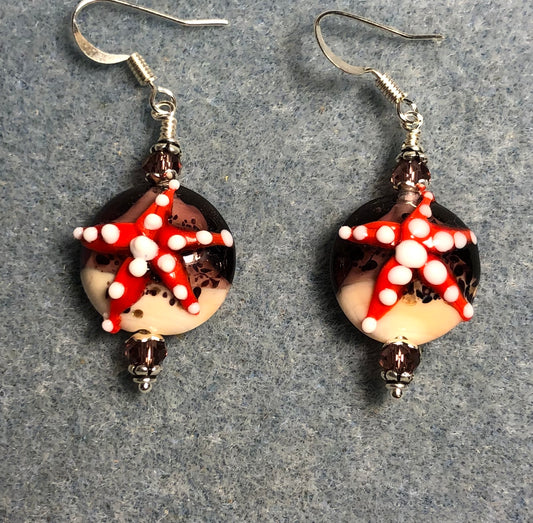 Lavender, red, and tan lamp work starfish bead earrings adorned with lavender Chinese crystal beads.