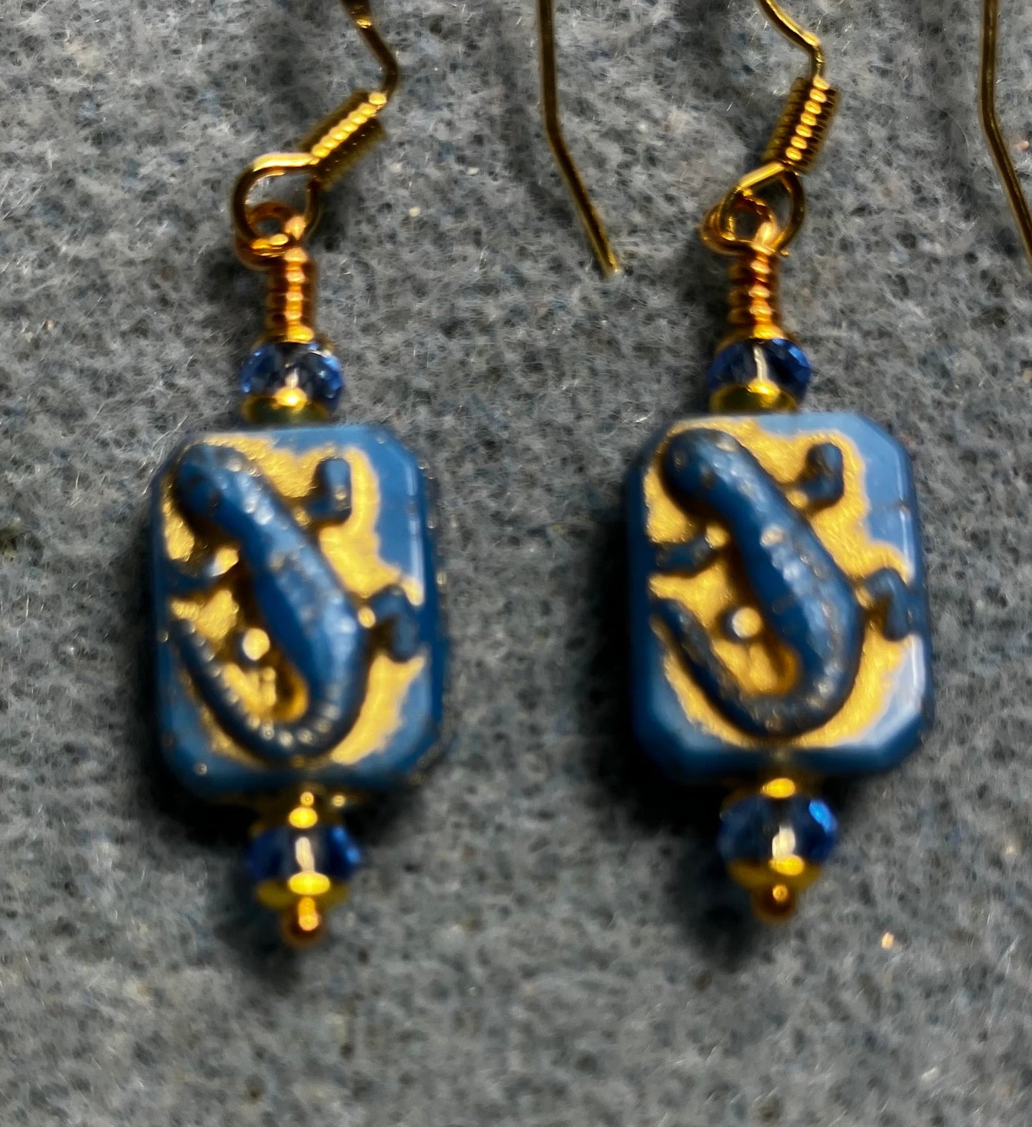 Small blue and gold Czech glass lizard bead earrings adorned with blue Chinese crystal beads.