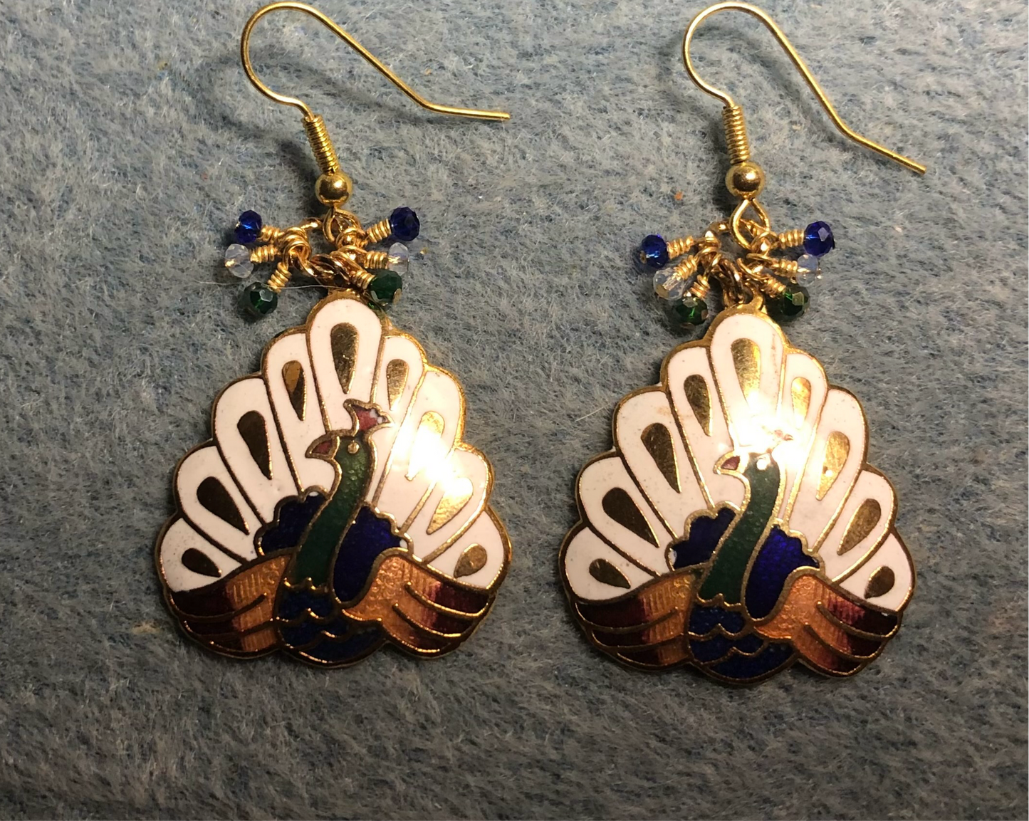 White, dark blue, and green cloisonné peacock charm earrings adorned with tiny white, dark blue, and green Chinese crystal beads.