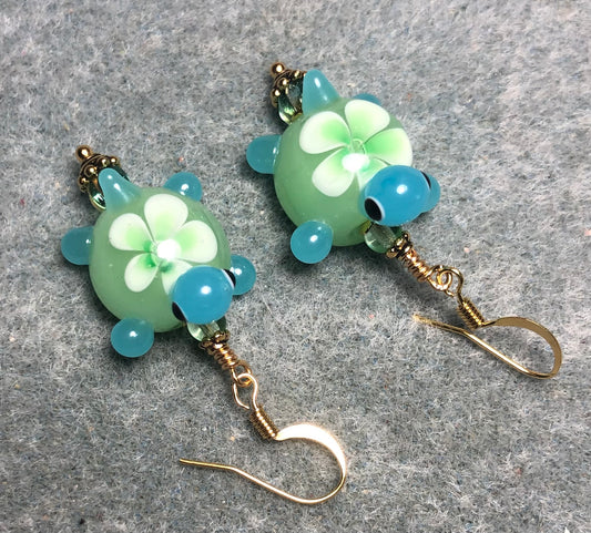 Light green and turquoise lamp work turtle bead earrings adorned with light green Czech glass beads.