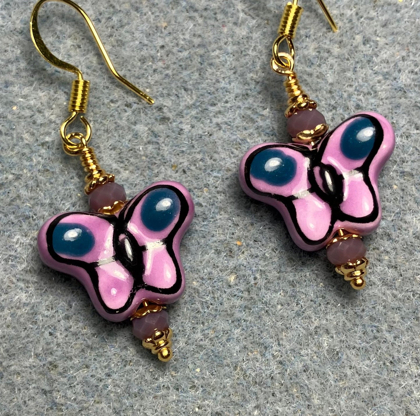Violet and purple ceramic butterfly bead earrings adorned with violet Chinese crystal beads.
