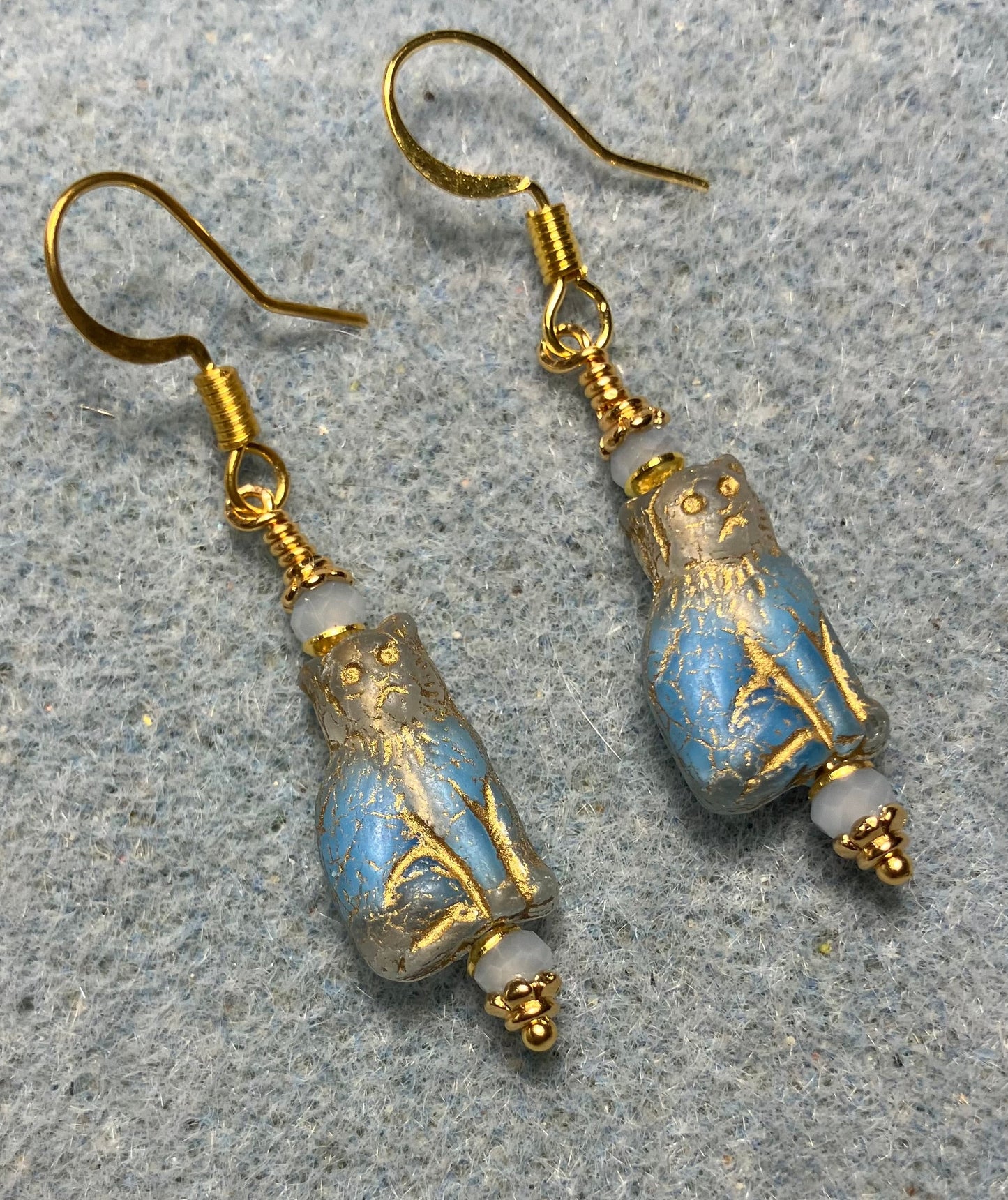 Small light blue and gold Czech glass cat bead earrings adorned with light blue Chinese crystal beads.