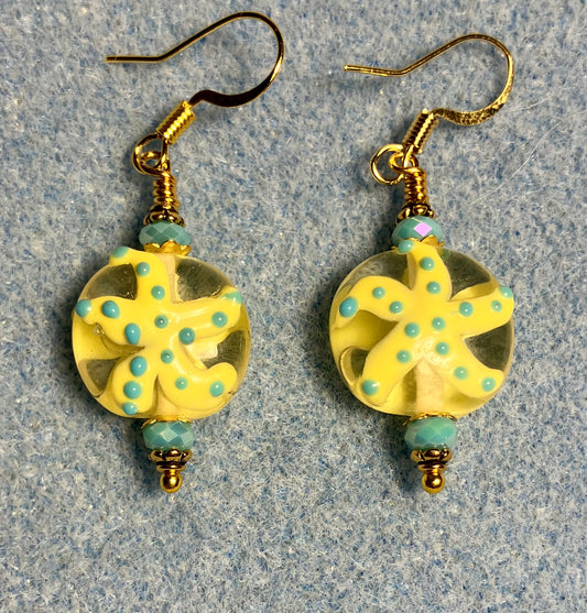 Yellow and turquoise lamp work starfish bead earrings adorned with turquoise Chinese crystal beads.