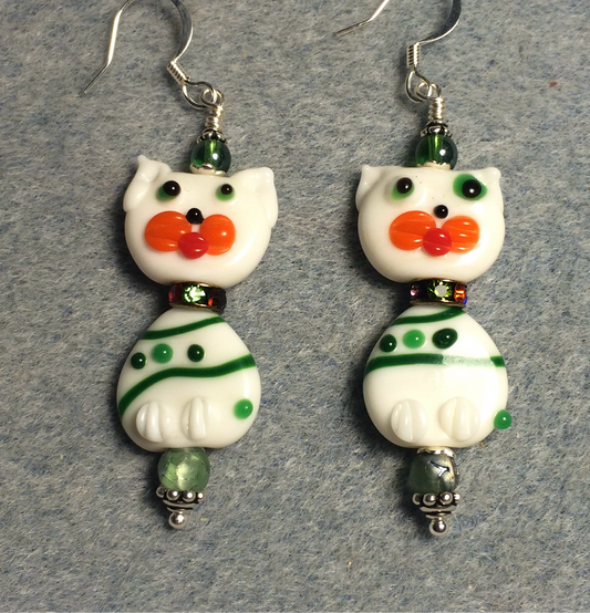 White and green lamp work cat bead earrings adorned with green rhinestone rondelle “collars” and green Czech glass beads.