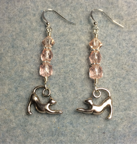 Silver stretching cat charm earrings adorned with light pink Czech glass beads