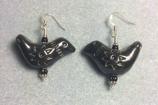 Large black ceramic songbird bead earrings adorned with black Czech glass beads.
