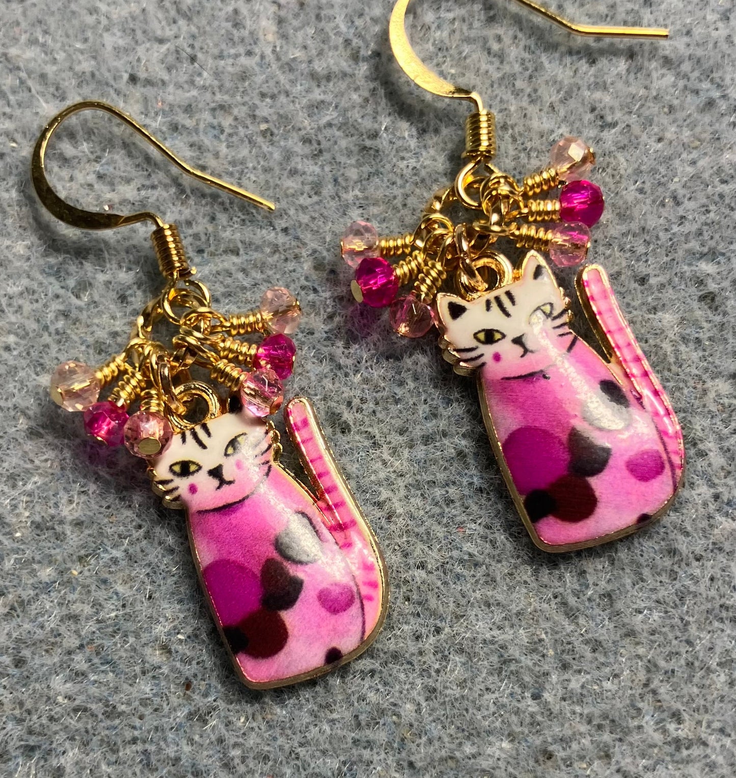 Hot pink and light pink enamel cat charm earrings adorned with tiny dangling hot pink and light pink Chinese crystal beads.