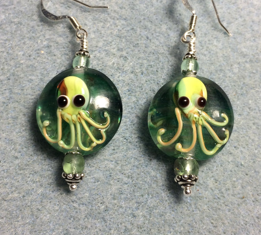 Light green and yellow lamp work octopus bead earrings adorned with light green Czech glass beads.