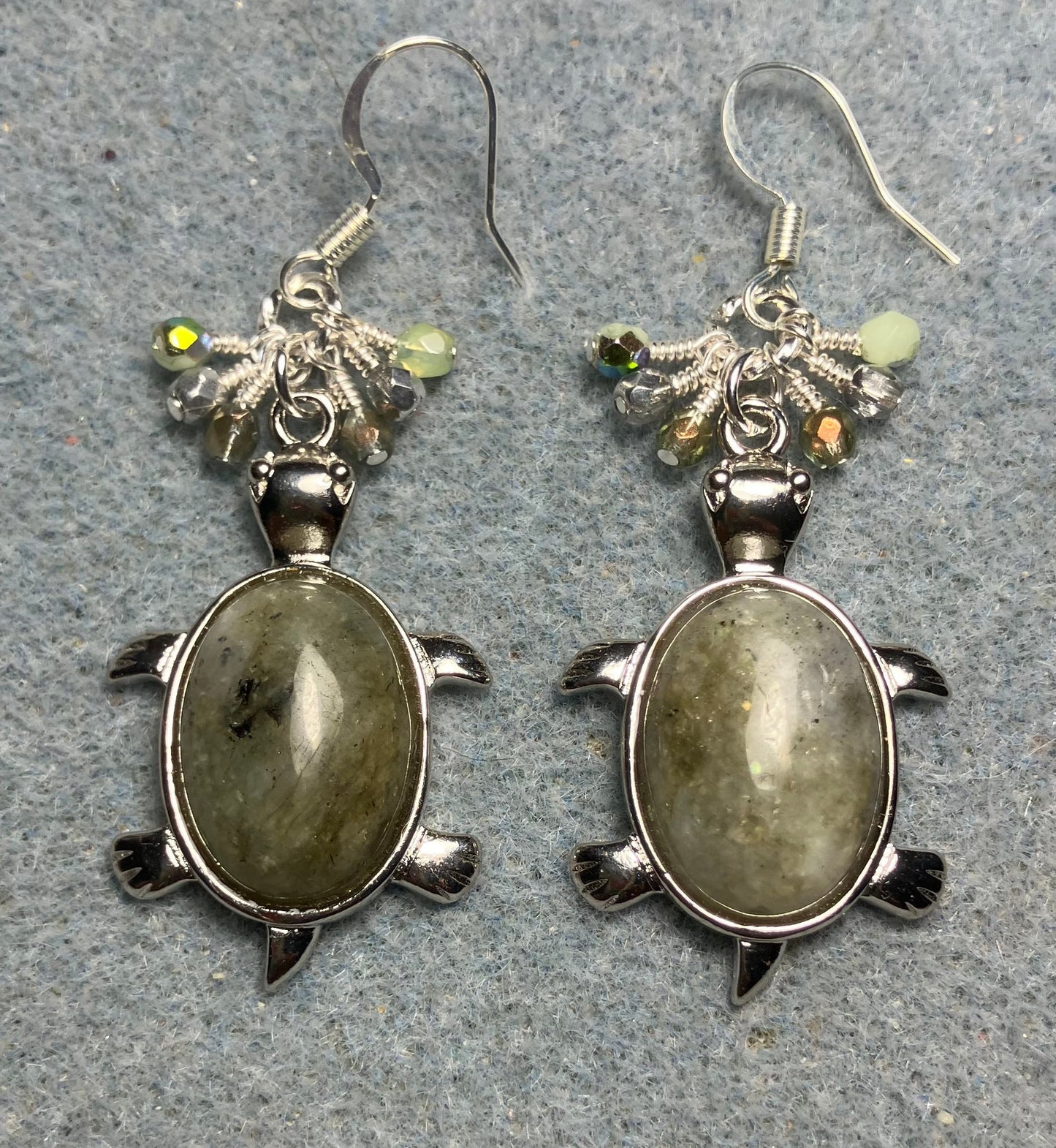 Large silver and green agate gemstone turtle charm earrings adorned with small dangling green and silver Czech glass beads.