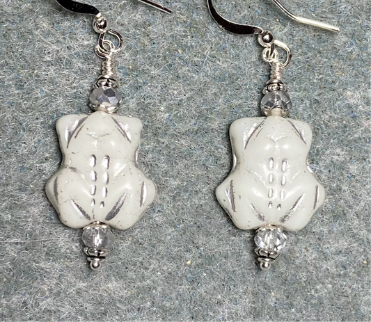 Opaque white (with silver inlay) Czech glass turtle bead earrings adorned with silver Chinese crystal beads.