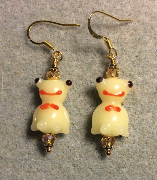 Opaque light yellow lamp work silly frog bead earrings adorned with topaz Chinese crystal beads.