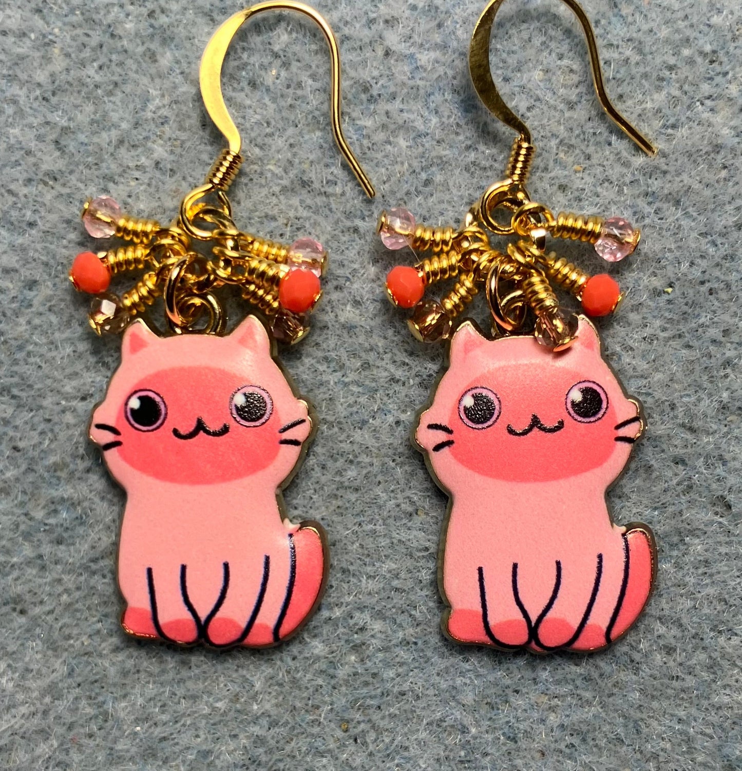 Pink enamel cat charm earrings adorned with tiny dangling pink and coral Chinese crystal beads.
