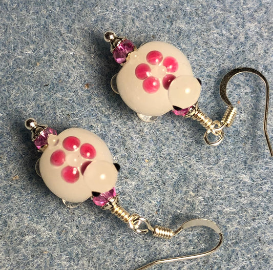 Small white and pink lamp work turtle bead earrings adorned with hot pink Chinese crystal beads.