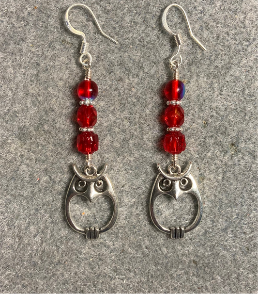 Silver owl charm earrings adorned with red Czech glass beads.