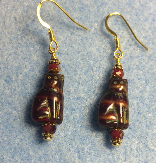 Small dark red and brown Czech glass cat bead earrings adorned with dark red Chinese crystal beads.