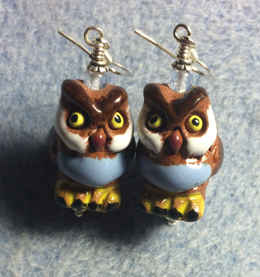 Large brown, light blue, and amber ceramic owl bead earrings adorned with light blue Czech glass beads.