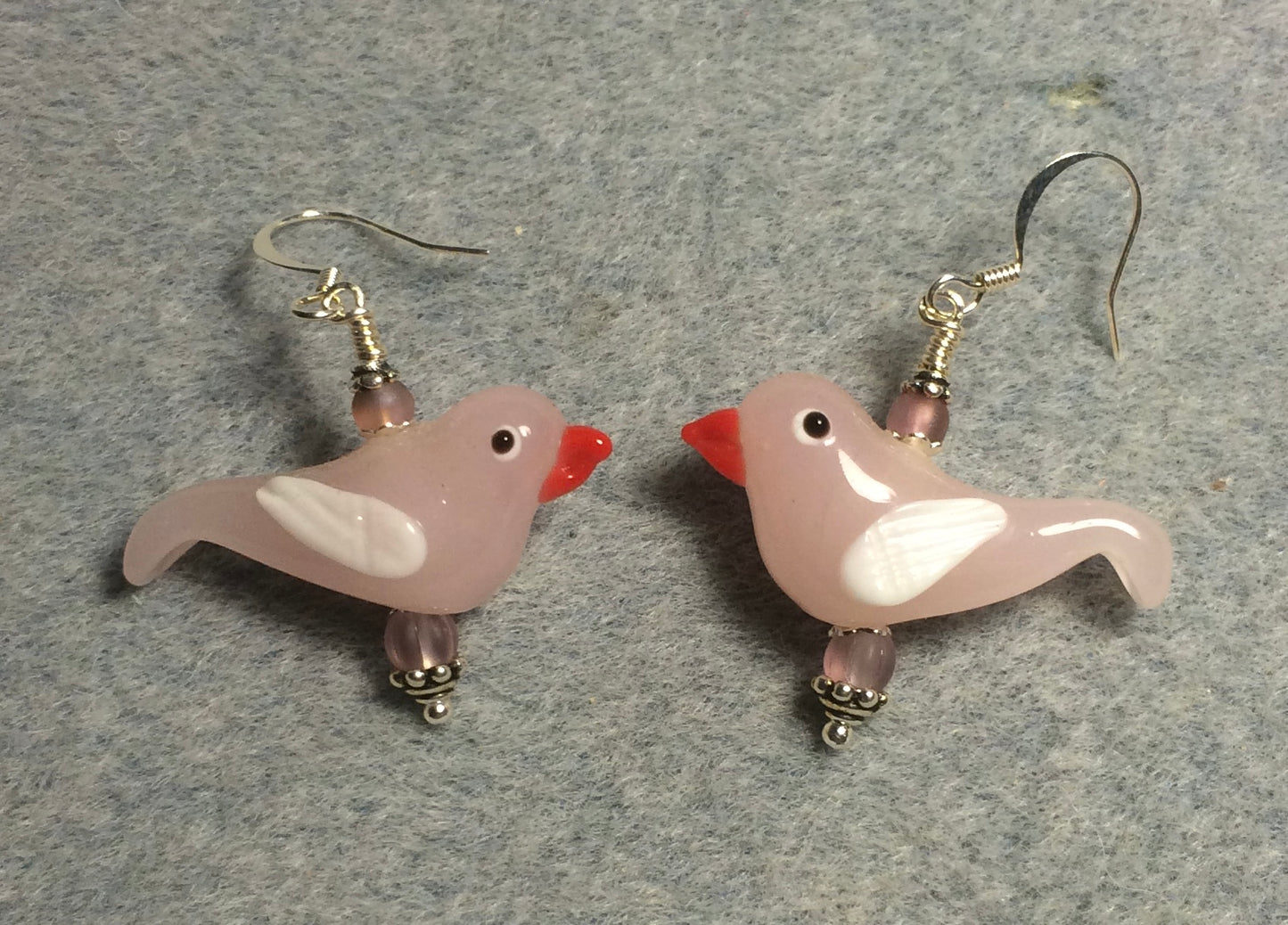 Milky pink and white lamp work songbird bead earrings adorned with light pink Czech glass beads.