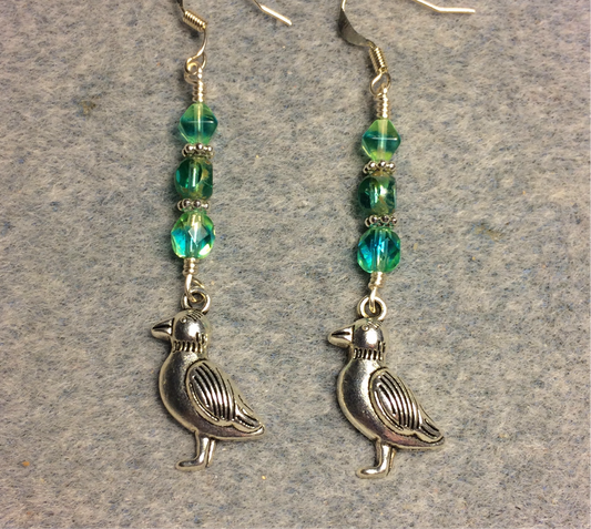 Silver bird charm earrings adorned with blue green Czech glass beads