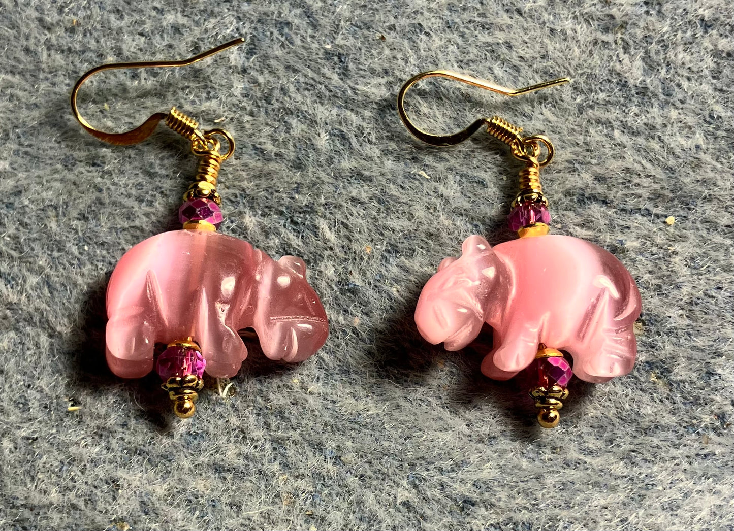 Pink fiber optic (cat’s eye) hippo bead earrings adorned with hot pink Chinese crystal beads.