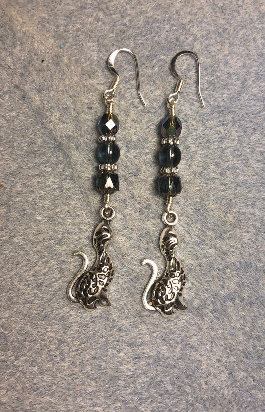 Long silver cat charm earrings adorned with Montana blue Czech glass beads