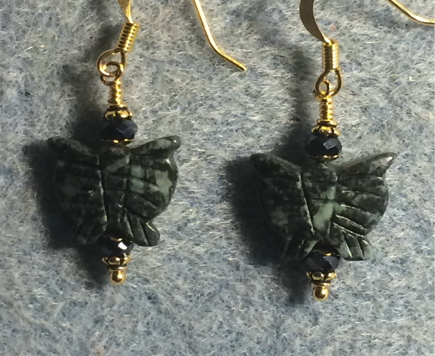 Green jasper gemstone butterfly bead earrings adorned with dark green Chinese crystal beads.