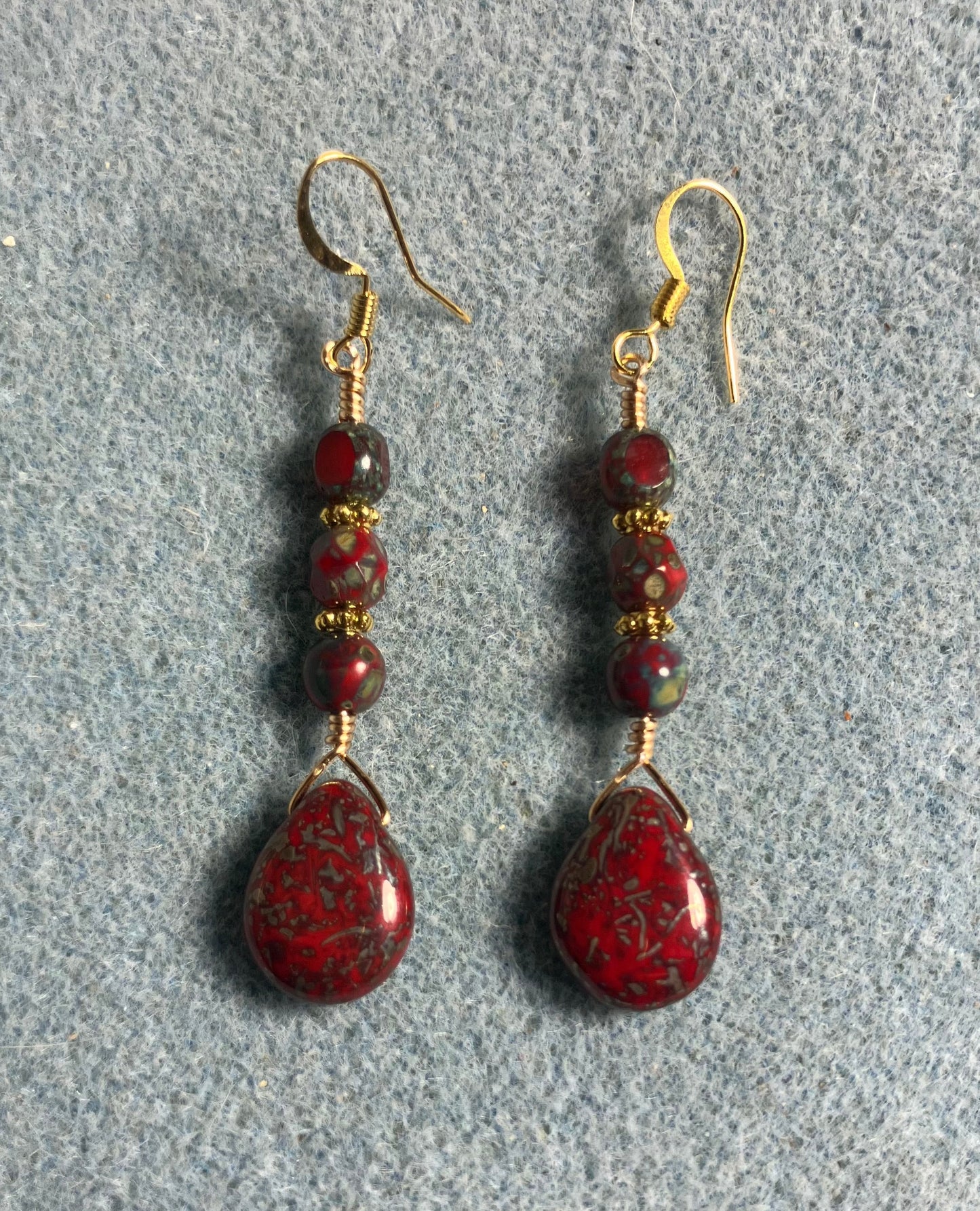 Dark red Picasso Czech glass pear drop bead earrings adorned with dark red Picasso Czech glass beads.