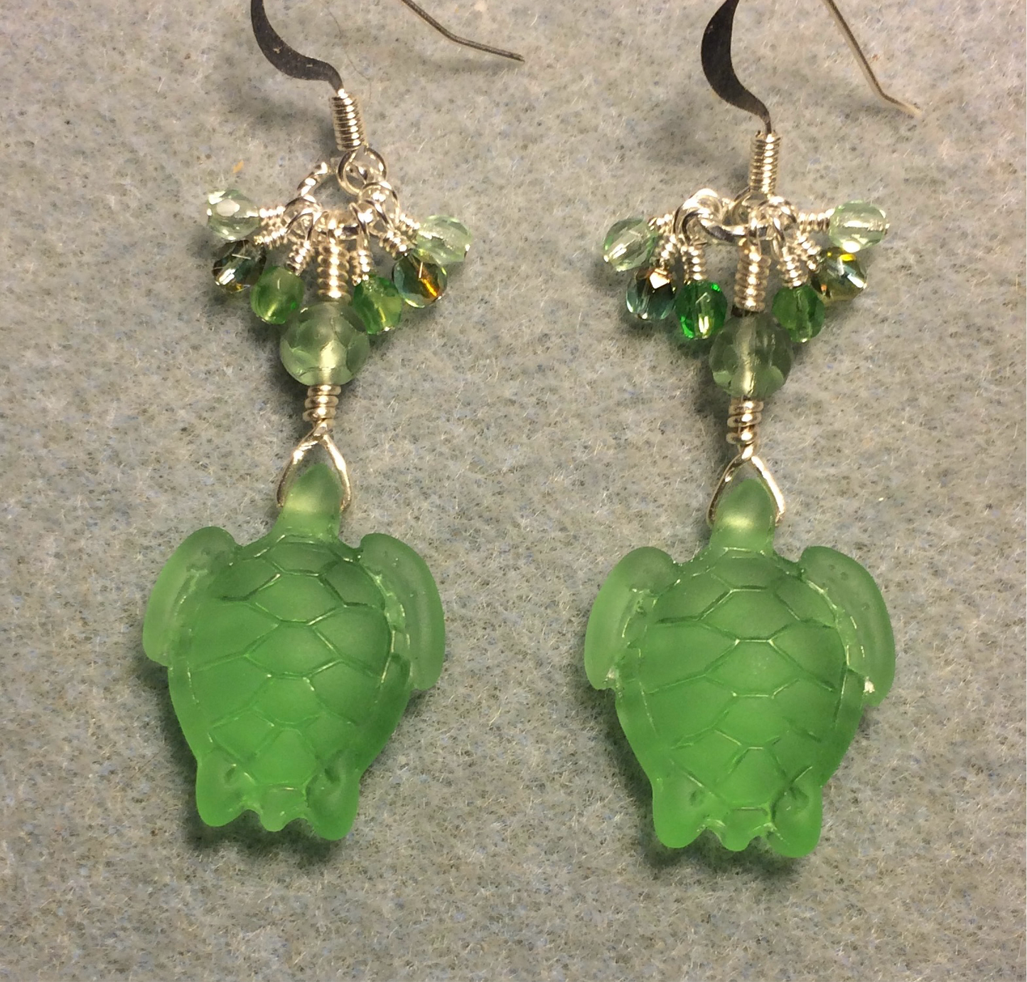 Lime green sea glass sea turtle bead earrings adorned with lime green Czech glass beads and small dangling lime green Czech glass beads.