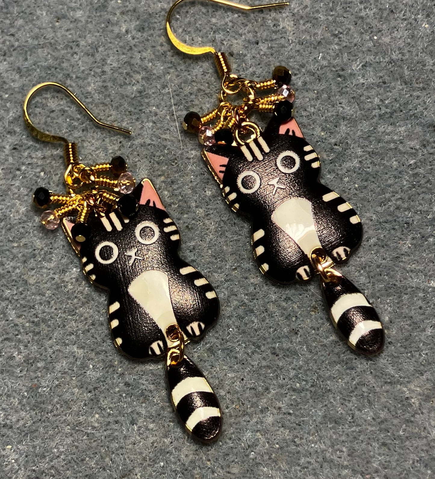 Black, white, and pink enamel cat charm earrings adorned with tiny dangling black, white, and pink Chinese crystal beads.