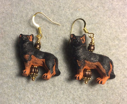Black and brown ceramic German Shepherd bead earrings adorned with brown Czech glass beads.