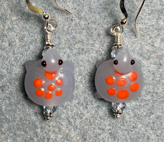 Light blue with orange spots lamp work turtle bead earrings adorned with light blue Chinese crystal beads.