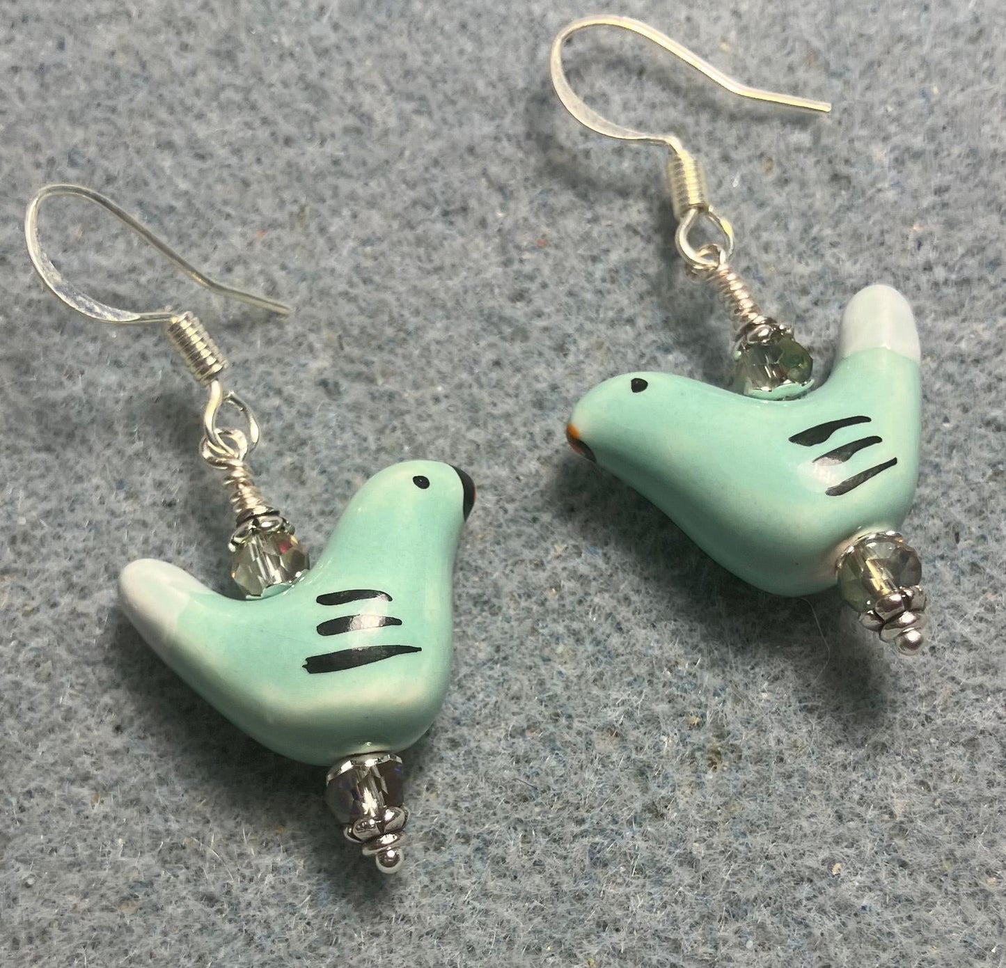 Small light green and white ceramic bird bead earrings adorned with light green Chinese crystal beads.