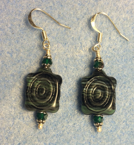 Dark green and black Czech glass turtle bead earrings adorned with dark green Chinese crystal beads.