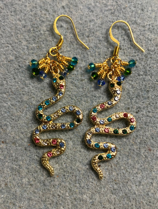 Gold and colored rhinestone coiled snake charm earrings adorned with tiny dangling turquoise, light blue, and dark green Chinese crystal beads.