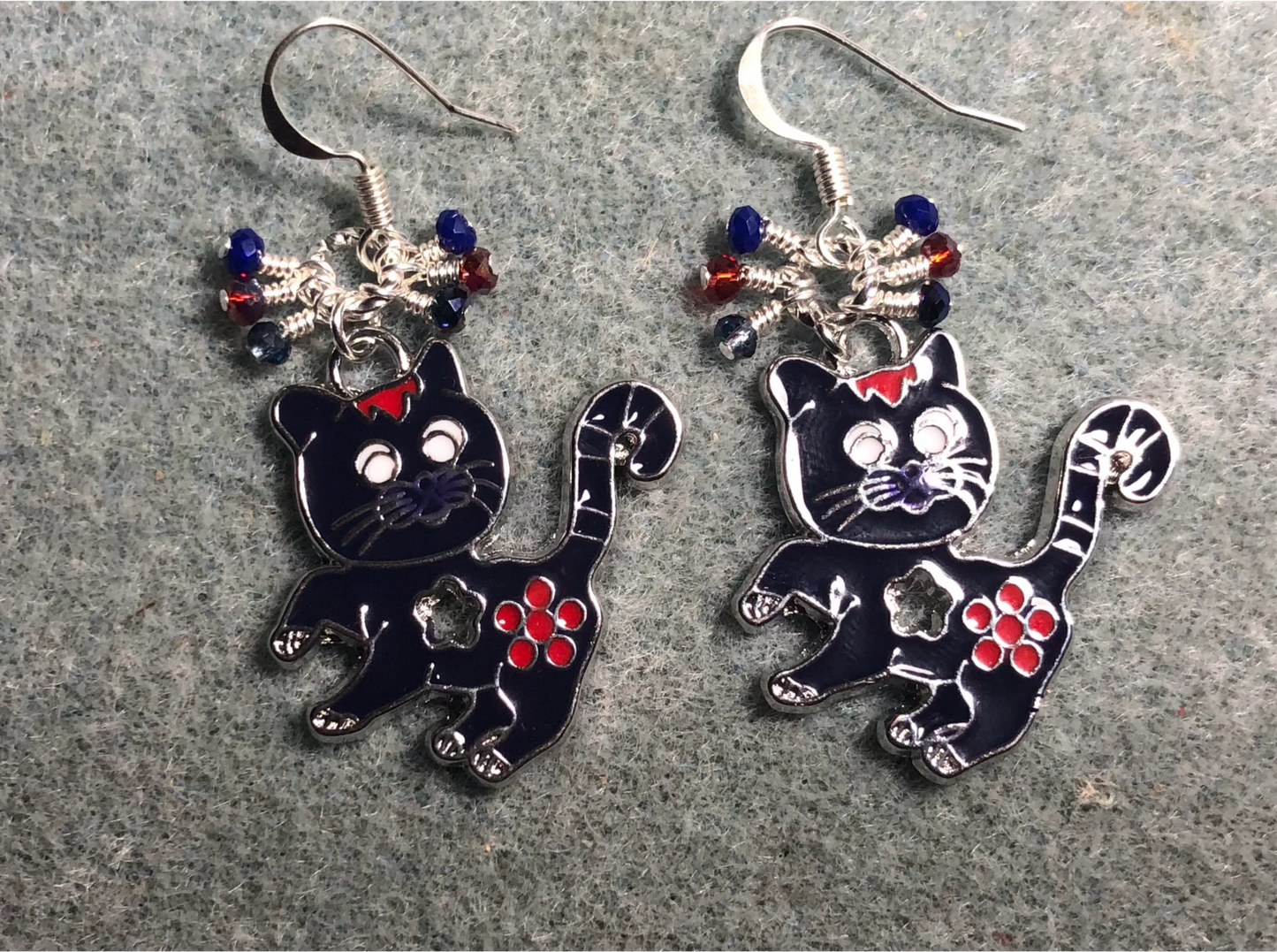 Dark blue and red enamel cat charm earrings adorned with tiny dangling dark blue and red Chinese crystal beads.