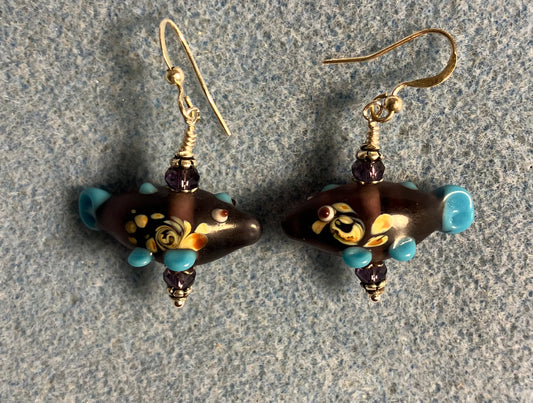 Purple lamp work fish bead earrings adorned with purple Chinese crystal beads.