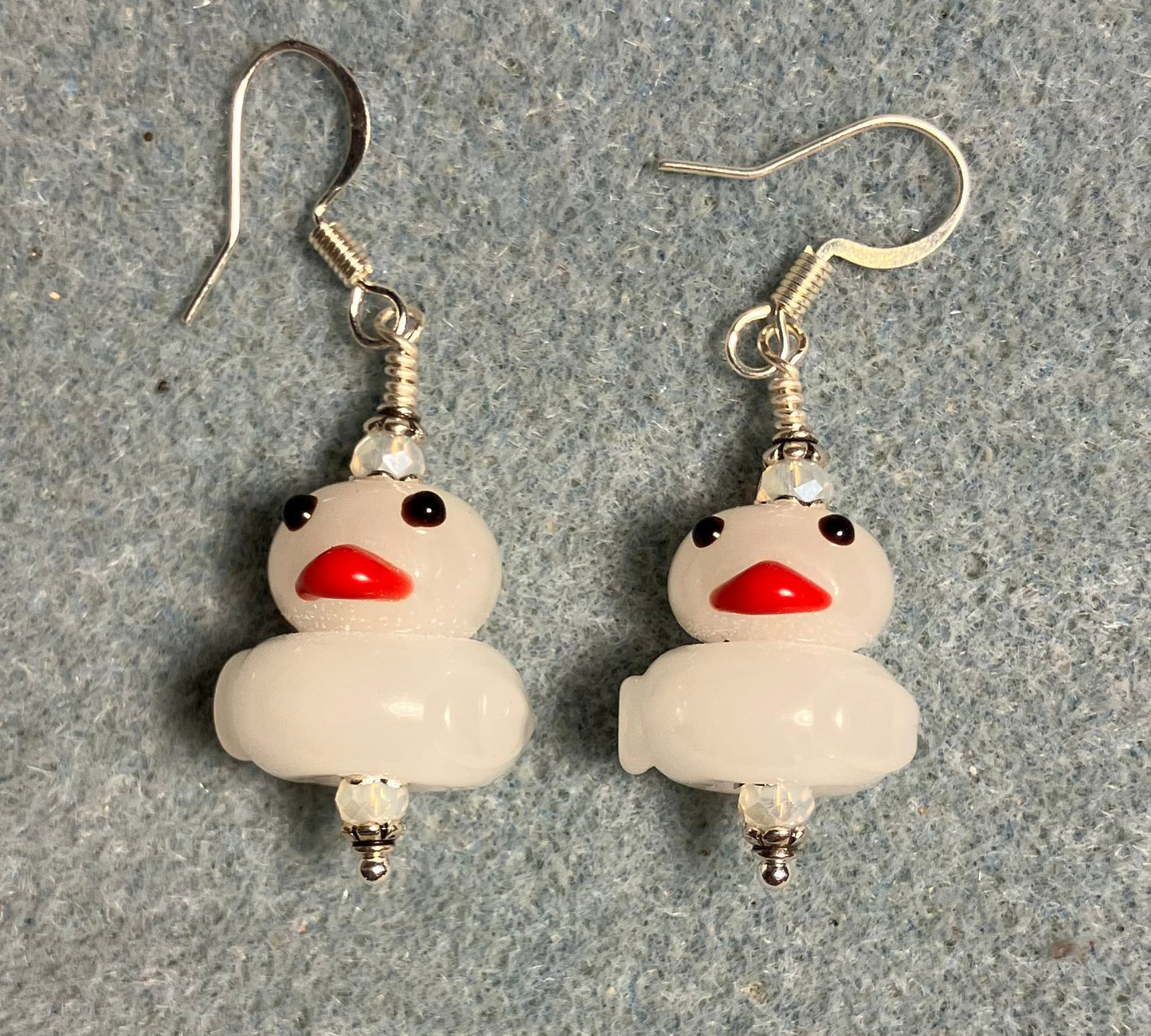 Opaque white lamp work duck bead earrings adorned with white Chinese crystal beads.
