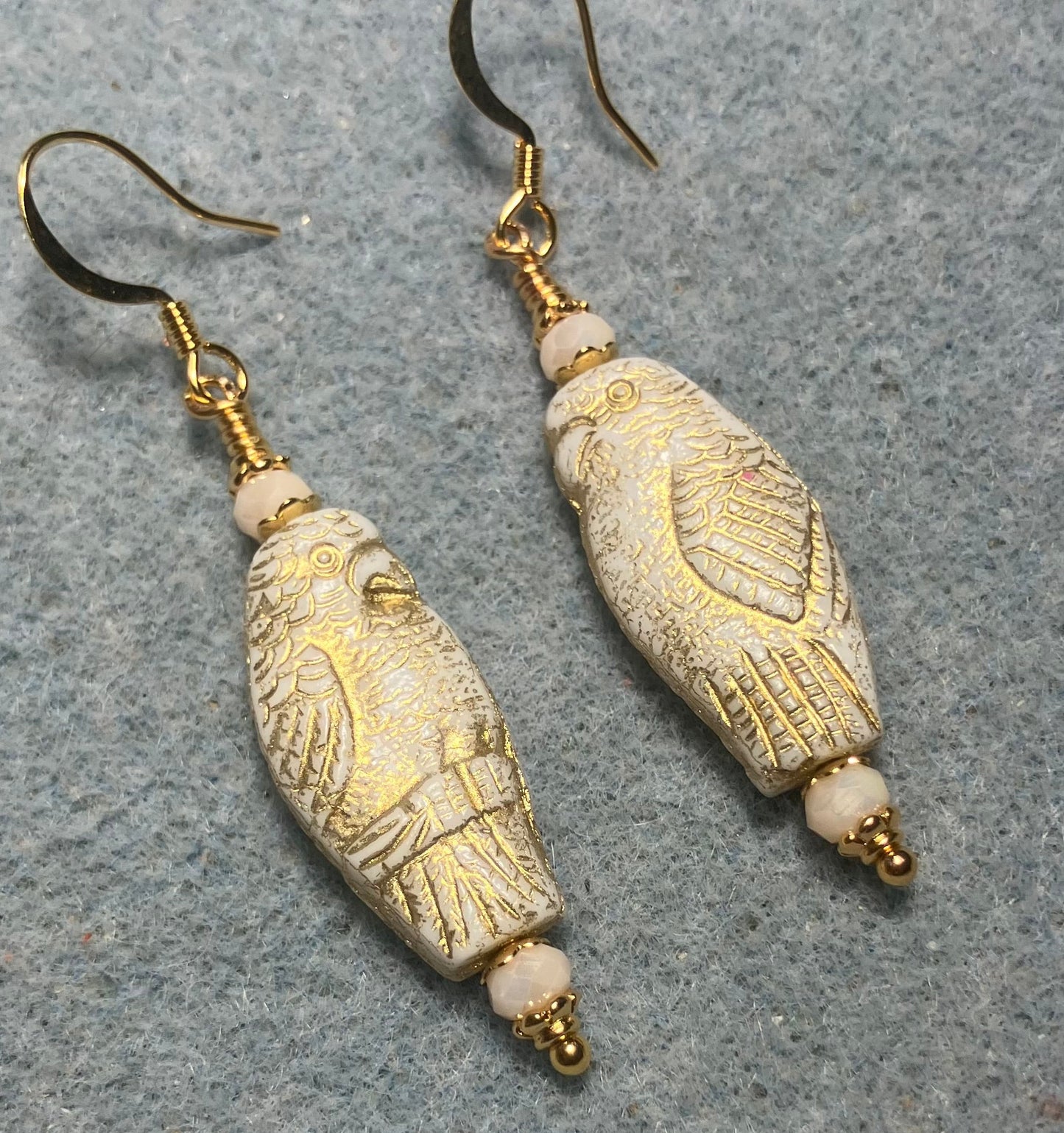 Large off white (with gold wash) Czech glass parrot bead earrings adorned with off white Chinese crystal beads.