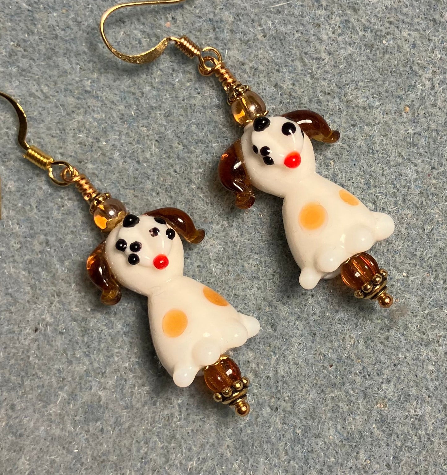 White and caramel lamp work puppy dog bead earrings adorned with caramel Czech glass beads.