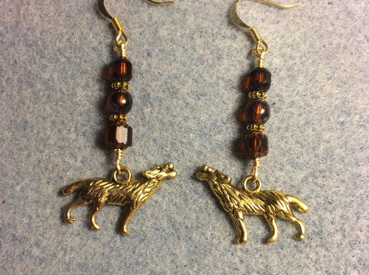 Gold howling wolf charm earrings adorned with brown Czech glass beads