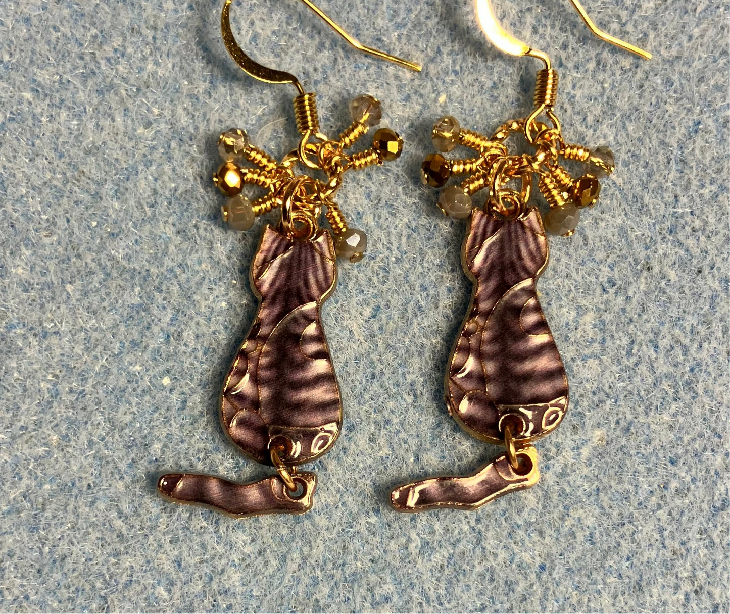 Brown and gold enamel tabby cat charm earrings adorned with tiny dangling brown, tan, and gold Chinese crystal beads.