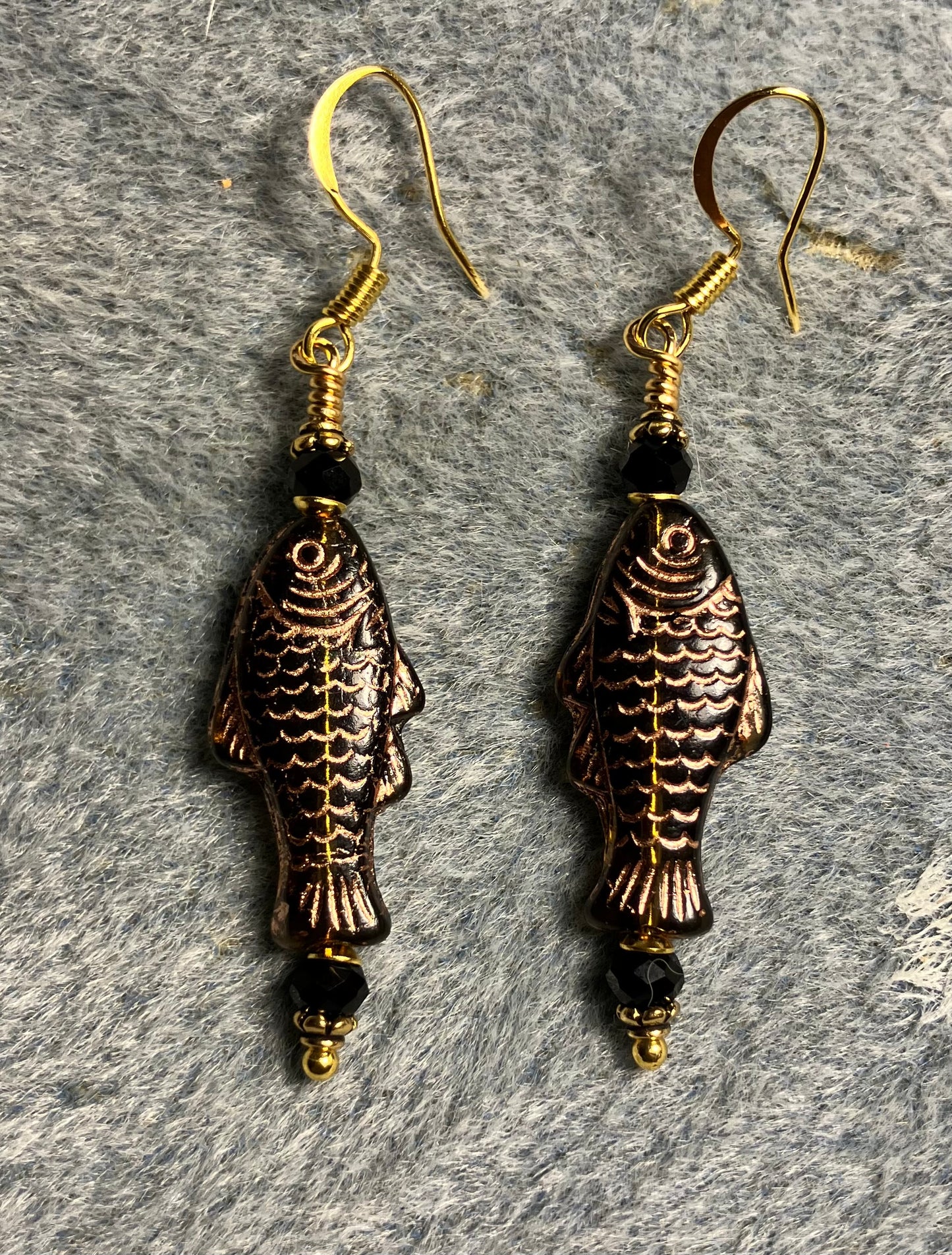 Black (with copper inlay) Czech glass fish bead earrings adorned with black Chinese crystal beads.