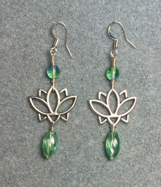 Silver lotus flower connector charm earrings adorned with light green Czech glass drop beads and light green Czech glass beads.