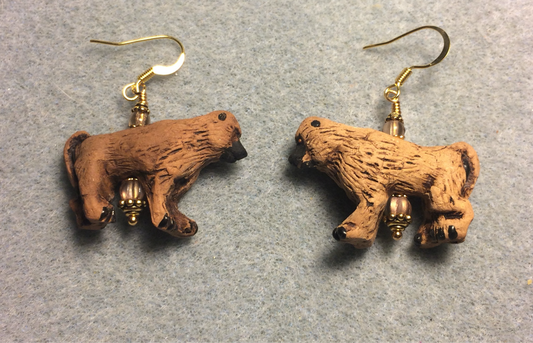Large brown ceramic baboon bead earrings adorned with light brown Czech glass beads.