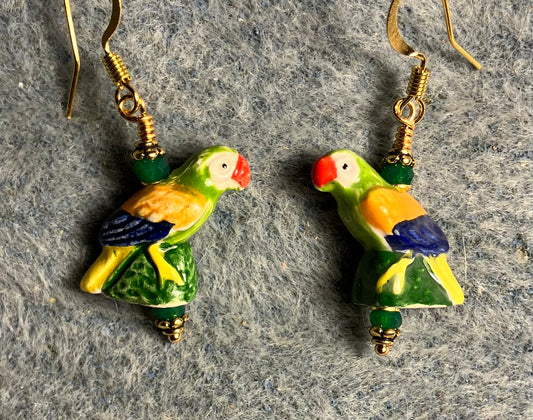 Small green, orange, blue, and red ceramic parrot bead earrings adorned with dark green Chinese crystal beads.