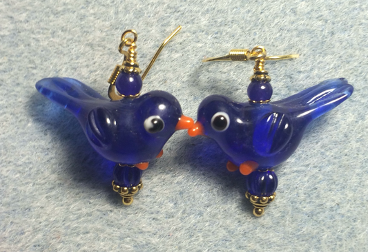 Translucent dark blue lamp work songbird bead earrings adorned with dark blue Czech glass beads.