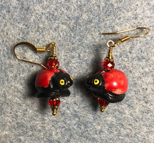 Red and black ceramic ladybug bead earrings adorned with red Chinese crystal beads.