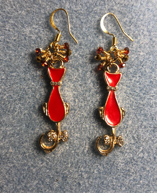 Red and gold enamel cat charm earrings adorned with tiny dangling red and gold Chinese crystal beads.